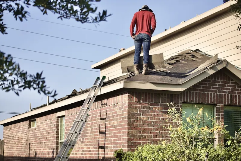 Professional roofer working on a residential roof in Connecticut College
